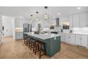 Modern kitchen with stainless steel appliances, large island and hardwood floors at 1406 Pika Rd, Boulder, CO 80302