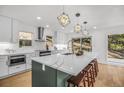 Gourmet kitchen with stainless appliances, quartz counters and a large center island at 1406 Pika Rd, Boulder, CO 80302