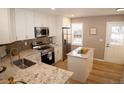 Bright, updated kitchen featuring granite counters, a center island, and stainless steel appliances at 19803 Victorian Way, Parker, CO 80138