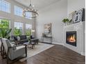 Spacious living room with fireplace, modern lighting, and hardwood floors at 5399 Valentia St, Denver, CO 80238