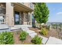 Welcoming front porch with stone accents and a beautifully landscaped garden at 23293 E Jamison Dr, Aurora, CO 80016