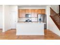 Bright kitchen features a spacious center island, stainless appliances and modern finishes at 23293 E Jamison Dr, Aurora, CO 80016