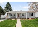 Charming single-story home with well-manicured lawn, inviting porch, and freshly painted light gray exterior at 1757 S Elm St, Denver, CO 80222