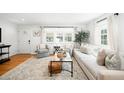 Bright living room with hardwood floors, large windows, comfortable seating, and stylish decor at 1757 S Elm St, Denver, CO 80222