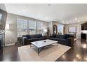 Bright living room with hardwood floors, modern decor, and large windows providing ample natural light at 10597 Casper St, Parker, CO 80134