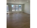 Bright living area featuring lots of natural light and beautiful wood flooring at 6657 E 149Th Dr, Thornton, CO 80602