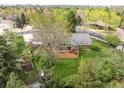 Aerial view of the home showcasing the expansive backyard with a large deck and lush greenery at 1800 S Niagara Way, Denver, CO 80224