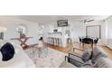 Cozy living room featuring modern furniture, sleek bar seating, and a mounted TV for comfortable and stylish living at 10185 W 25Th Ave # 31, Lakewood, CO 80215