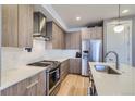 Contemporary kitchen with stainless steel appliances, sleek cabinets, and marble countertops at 1439 Garfield St, Denver, CO 80206
