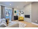 Comfortable living room with a fireplace, large windows, and access to the backyard at 1439 Garfield St, Denver, CO 80206