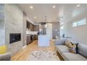 Bright living area with a fireplace, modern kitchen, dining area and hardwood floors at 1439 Garfield St, Denver, CO 80206