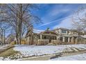 Attractive brick home with snowy front yard and mature trees at 1395 S Josephine St, Denver, CO 80210