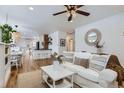 Bright living room with hardwood floors, a ceiling fan, and an open layout at 1395 S Josephine St, Denver, CO 80210