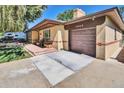 Inviting ranch-style home with a well-kept lawn, attached garage, and charming front porch area at 4960 S Fox St, Englewood, CO 80110