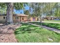 Attractive home featuring a manicured lawn, mature trees, and a welcoming walkway to the front door at 4960 S Fox St, Englewood, CO 80110