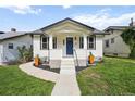 Beautiful home with a bright blue front door and landscaped front yard at 3226 Grant St, Englewood, CO 80113