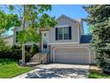 Beautiful two-story home with a well-maintained lawn, mature landscaping, and an attached two-car garage at 11182 W 103Rd Cir, Broomfield, CO 80021