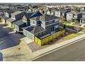 Aerial view of neighborhood homes with solar panels and fenced in yard at 2754 W 69Th Ave, Denver, CO 80221