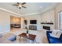 Spacious living room features a cozy fireplace, modern furniture, and ample natural light at 4689 Coltin Trl, Castle Rock, CO 80104