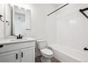Clean bathroom with a vanity, toilet, and tiled shower-tub combination at 1402 Rock Cliff Ave, Erie, CO 80516