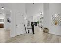 Bright foyer leading to the open-concept living area with hardwood floors and modern finishes at 1894 S Marshall Cir, Lakewood, CO 80232