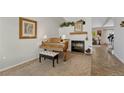 Carpeted living area with white brick fireplace and a vintage piano at 9662 Newcastle Dr, Highlands Ranch, CO 80130