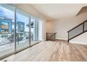 Bright living room with hardwood floors and sliding glass door to deck at 780 Josephine Way, Superior, CO 80027