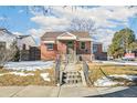 Brick ranch home with a covered porch and steps leading to the front entrance at 2895 Dexter St, Denver, CO 80207