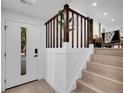 Bright entryway with wooden stairs, white walls and modern fixtures at 1517 S Elkhart St, Aurora, CO 80012