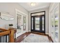 Inviting foyer featuring a decorative front door, hardwood floors, and an elegant staircase at 20413 Bald Mountain Ct, Monument, CO 80132