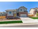 A beautifully landscaped two-story home with a brick facade, a spacious driveway, and a well-manicured lawn at 434 W 128Th Dr, Westminster, CO 80234