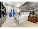 Charming bedroom with a wood accent wall, plush carpet, and large window for natural light at 7600 Landmark Way # 1514, Greenwood Village, CO 80111