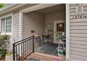 Inviting covered porch with seating area, stylish décor, and charming exterior details at 13781 E Marina Dr # A, Aurora, CO 80014