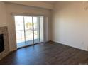 Living room with hardwood floors, fireplace, and access to balcony at 15700 E Jamison Dr # 5-307, Englewood, CO 80112
