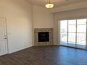 Living room with hardwood floors, fireplace, and sliding glass doors at 15700 E Jamison Dr # 5-307, Englewood, CO 80112