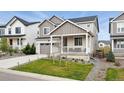 Charming two-story home with a well-manicured lawn and a covered front porch at 1101 E Witherspoon Dr, Elizabeth, CO 80107