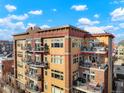 Multi-story building featuring private balconies with outdoor seating on each level at 1925 W 32Nd Ave # 502, Denver, CO 80211