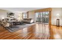 Spacious living room with wood floors, neutral decor, large windows, and sliding glass door to the balcony at 350 S Clinton St # 9C, Denver, CO 80247