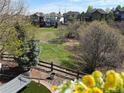 Serene backyard view from deck featuring lush greenery, mature trees, and a relaxing hammock at 12380 Jasper Pointe Way, Castle Pines, CO 80108