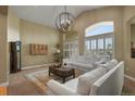 Cozy living room with ample natural light, stylish furniture, and a refined decorative style at 12380 Jasper Pointe Way, Castle Pines, CO 80108