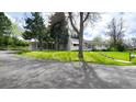 Inviting ranch-style home with mature trees, green lawn, and charming curb appeal at 1930 Taft Dr, Lakewood, CO 80215