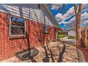 Brick patio area with window well and white painted trim near backyard at 2274 S Cherry St, Denver, CO 80222