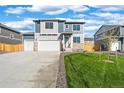 A well-maintained home with a two-car garage, green lawn, and stylish exterior design under blue sky at 3234 Belleville Ridge Rd, Elizabeth, CO 80107