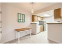 Eat in kitchen featuring light wood cabinetry and standard appliances at 8335 Fairmount Dr # 7-207, Denver, CO 80247