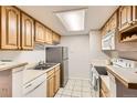 Functional kitchen featuring light wood cabinetry and standard appliances at 8335 Fairmount Dr # 7-207, Denver, CO 80247