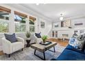 Bright living room featuring large windows, cozy seating, and refinished hardwood floors at 2641 N Clayton St, Denver, CO 80205