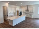 Open concept kitchen features a large center island, stainless steel appliances, and white cabinetry at 1111 Joseph Pl, Erie, CO 80026