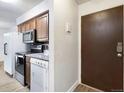 Kitchen with granite countertops, stainless steel appliances, and laundry at 7455 E Quincy Ave # 101, Denver, CO 80237