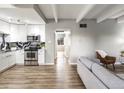 Open-concept living space with sleek floors seamlessly connects the living area to the updated kitchen at 384 S Ironton St # 408, Aurora, CO 80012