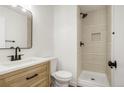 Updated bathroom featuring a wood vanity and tiled stand-up shower at 3643 S Mobile Way, Aurora, CO 80013